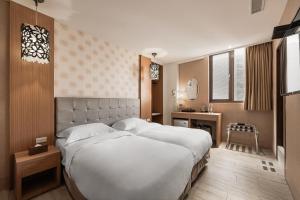 Krevet ili kreveti u jedinici u okviru objekta The Riverside Hotel Hengchun