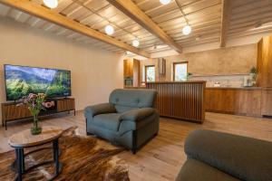 a living room with a couch and a chair at Sodyba "Baltalaukis" in Didžiosios Kabiškės