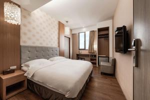 Krevet ili kreveti u jedinici u okviru objekta The Riverside Hotel Hengchun