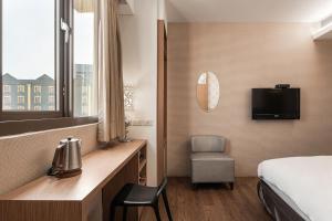 Krevet ili kreveti u jedinici u okviru objekta The Riverside Hotel Hengchun