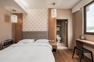 Krevet ili kreveti u jedinici u okviru objekta The Riverside Hotel Hengchun