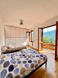 Postel nebo postele na pokoji v ubytování Chalet Del Bosco - Piccola Svizzera