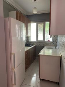 Una cocina con un refrigerador blanco y una ventana. en Bursa central house, en Bursa
