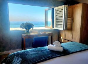 a bedroom with a bed with a view of the ocean at Copper Beach Villa 2 Umdloti in Umdloti