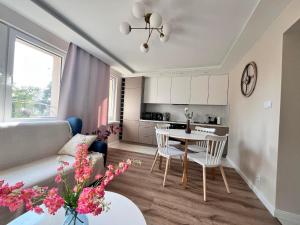 a living room with a couch and a table at Prestige Apartment Bohaterów Warszawy in Kielce