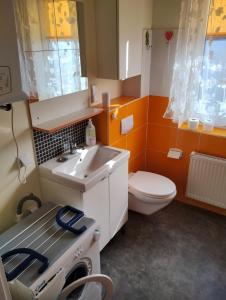 a small bathroom with a sink and a toilet at Pepe Apartment 40 mkw in Szczecin +15 photos