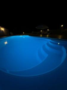 a blue hot tub in a dark room at Vila Rosu in Pucioasa