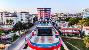 a cruise ship in the middle of a city at Granada Luxury Red Adult Only in Alanya