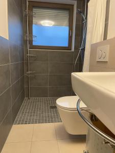 a bathroom with a toilet and a sink at Appartement Kirschblüte in Seehof +20 photos