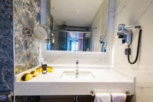 a bathroom with a sink and a mirror at Granada Luxury Red Adult Only in Alanya