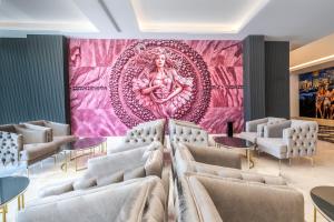 a room with chairs and a large painting on the wall at Granada Luxury Red Adult Only in Alanya