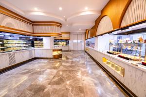 a large kitchen with a counter in a restaurant at Granada Luxury Red Adult Only in Alanya