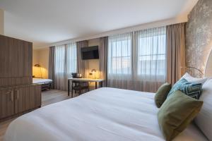 Postel nebo postele na pokoji v ubytování Leonardo Hotel Breda City Center