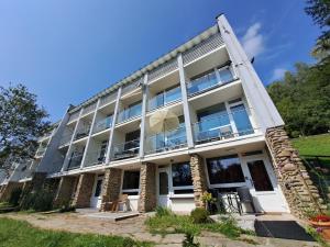 a large white building with a lot of windows at Apartament Piętnastka Ustroń in Ustroń