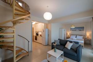 a living room with a couch and a bed at HomEasy Apartments - Kalamata Central Getaways with Private Parking in Kalamata
