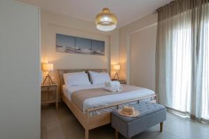 a bedroom with a bed with two towels on it at HomEasy Apartments - Kalamata Central Getaways with Private Parking in Kalamata