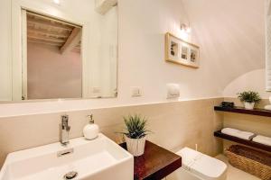 a bathroom with a white sink and a mirror at YH Suite in Rome