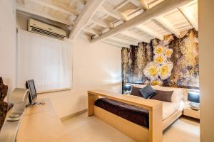 a bedroom with a bed and a wall with a flower mural at YH Suite in Rome