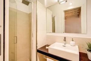 a white bathroom with a sink and a mirror at YH Suite in Rome