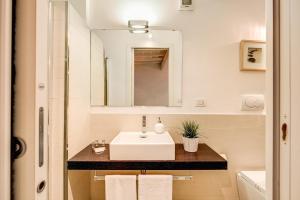 a bathroom with a sink and a mirror at YH Suite in Rome