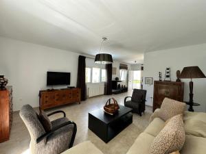 a living room with two couches and a tv at Wonderful private villa near beach with sea views in Marbella