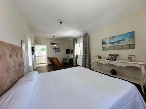 a bedroom with a large white bed in a room at Wonderful private villa near beach with sea views in Marbella +45 photos