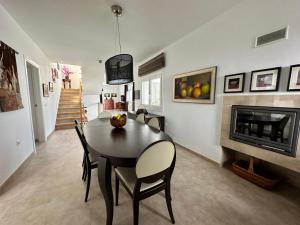 a dining room with a table and a fireplace at Wonderful private villa near beach with sea views in Marbella