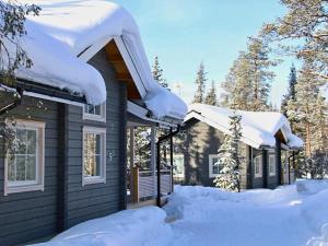 a house covered in snow with snow covered roofs at Arctic Home Experience in Äkäslompolo