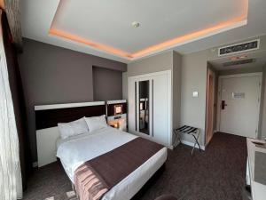 Postel nebo postele na pokoji v ubytování Sam Royal Hotel