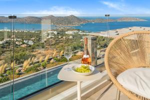 a balcony with a table with a bowl of fruit and wine glasses at Sole Mare Luxury Villa With Sea View & Private Pool in Elounda in Elounda +86 photos