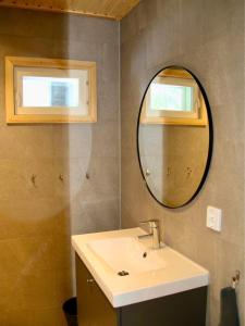 a bathroom with a sink and a mirror at Arctic Home Experience in Äkäslompolo +22 photos
