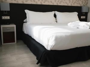 Postel nebo postele na pokoji v ubytování Hotel Plaza Las Matas