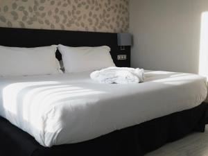 Postel nebo postele na pokoji v ubytování Hotel Plaza Las Matas