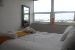 a bedroom with a white bed with two towels on it at Flat 414 One bedroom apartment in Birmingham