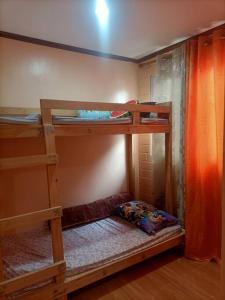 a bedroom with two bunk beds in a room at Colorado Dos, Jubay Liloan Cebu in Cotcot