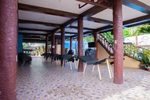 a patio with chairs and a staircase in a building at Balai La Niña Beach Resort in Carmen