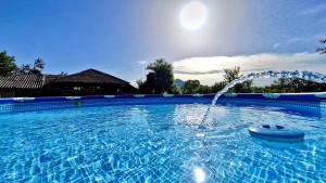 a large swimming pool with a water fountain at Ралчевата къща in Elena