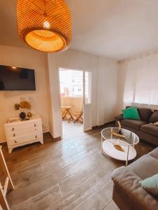 a living room with a couch and a table at Pitayas Apartment in Corralejo