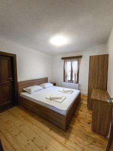 a bedroom with a large bed and a window at Ралчевата къща in Elena +12 photos