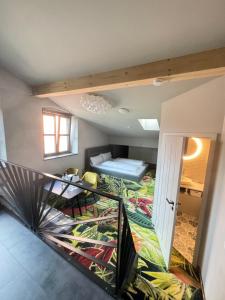 a room with a staircase and a room with a bed at Pebbles Suiten by RiNG in Regensburg
