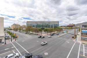 a city street with cars driving down a road at 2bd 2ba Best style and location Pool spa gym pkg! in American Towers Condominium