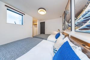 a bedroom with two beds and a window at Modern Japan 東京浅草 east in Tokyo +92 photos