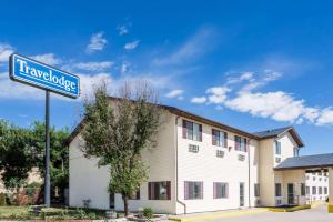 a building with a sign for a hotel at Travelodge by Wyndham Longmont in Longmont