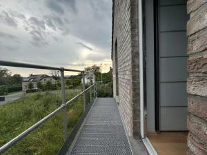 a walkway leading to the door of a house at Au Charme de Durbuy in Durbuy