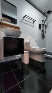 a bathroom with a toilet and a sink at 2Sleep DMK Airport Bangkok in Ban Ko