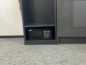 a black microwave oven sitting next to a wall at Nottingham Studio-CityCentre-Tv-Wifi in Nottingham