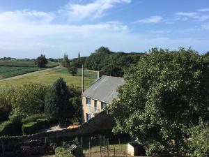 a house in the middle of a field at La Petite Ville Aze in Saint-Coulomb