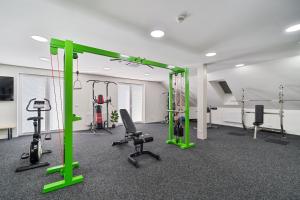 a gym with green equipment and tread machines at Apartmány Jakub in Příseka