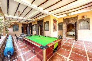 a pool table in the middle of a room at DAR SMAWAR top piscine chauffée 15mn centre ville in El Caïd Omar