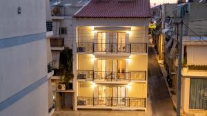 an apartment building with balconies on a city street at HomEasy Apartments - Kalamata Central Getaways with Private Parking in Kalamata